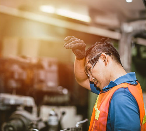 Worker experiencing heat stress at an industrial worksite